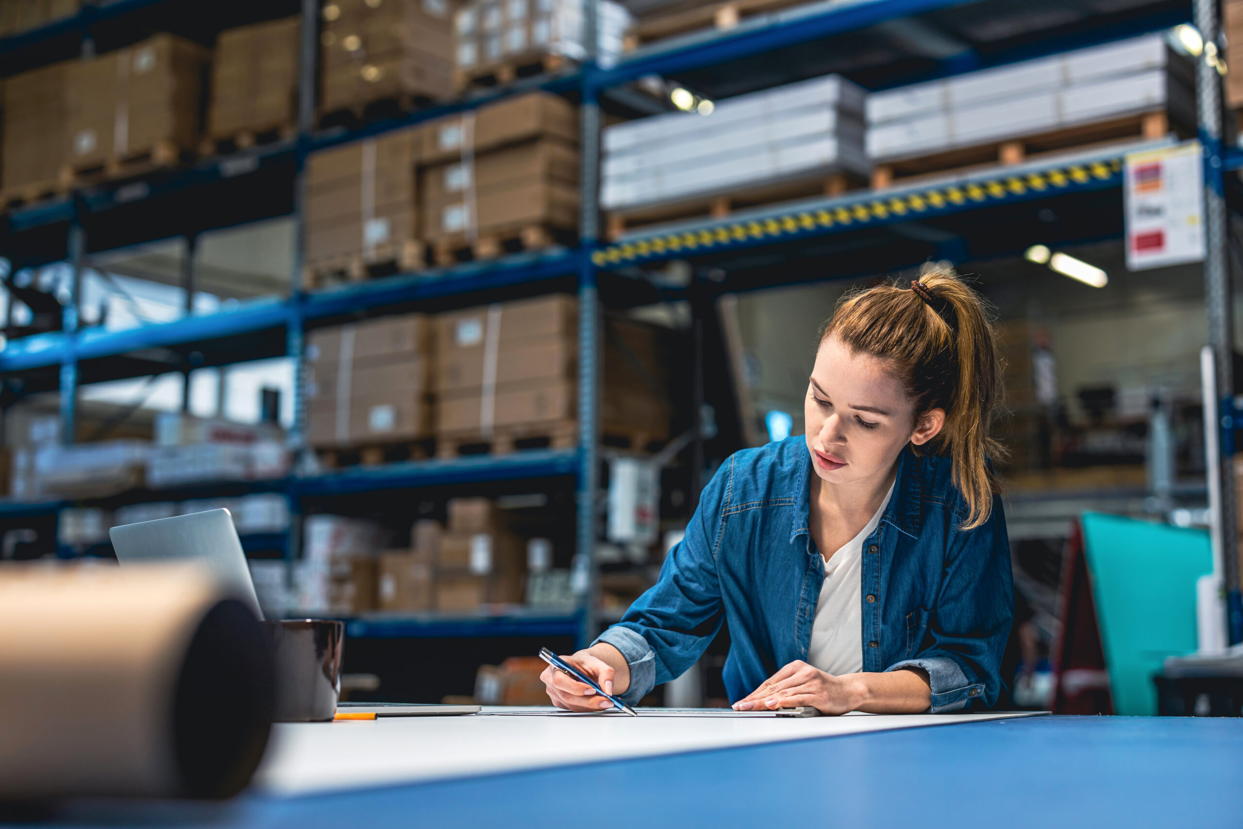 A girl working on Supply and Logistics management in a warehouse